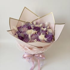 Purple soy wax candle bouquet being arranged
